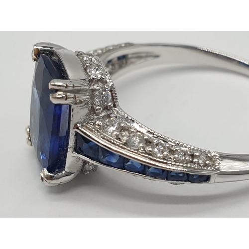 32 - 18ct White gold ring with sapphire and diamonds. Weighs 3.2g and is a size N.