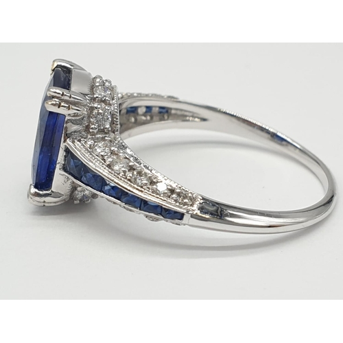 32 - 18ct White gold ring with sapphire and diamonds. Weighs 3.2g and is a size N.