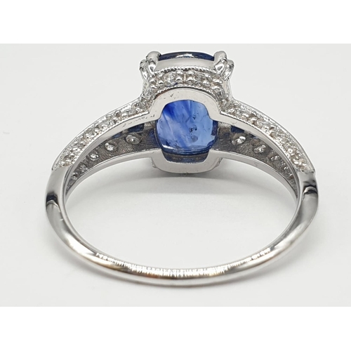 32 - 18ct White gold ring with sapphire and diamonds. Weighs 3.2g and is a size N.