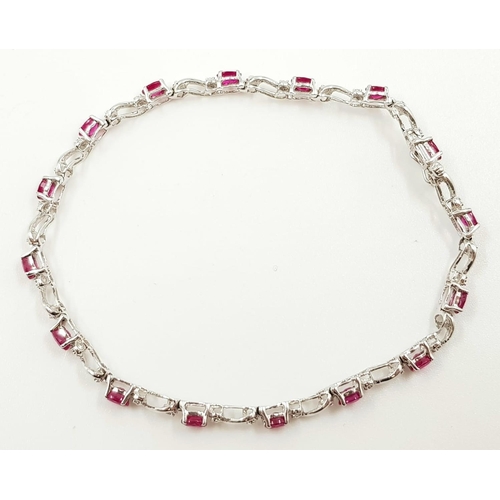 341 - A ruby and diamond ladies bracelet on 9ct white gold. 6.2g total weight and 19cm long.