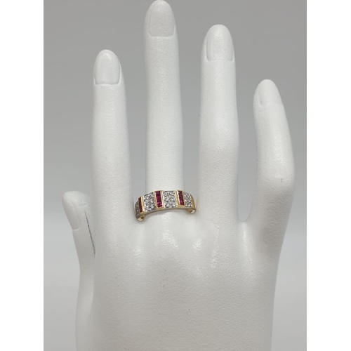 39 - 18ct Gold diamond and ruby ring. Weighs 5.1g and size Q.