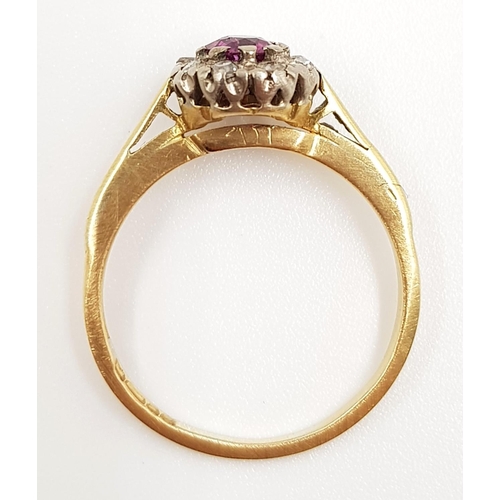 401 - An 18ct gold, ruby and diamond cluster ladies ring. 2.9g total weight and size N.