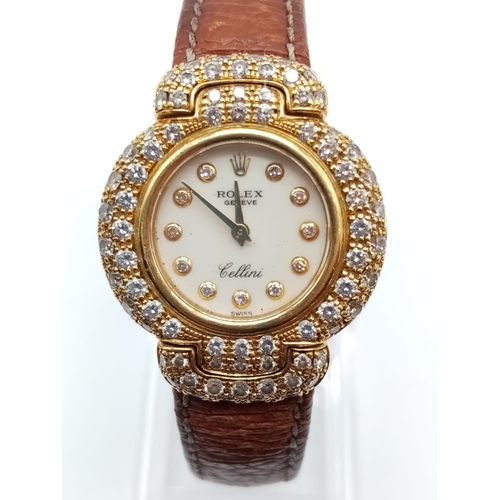 119 - Vintage 18ct gold Rolex Geneve Cellini ladies watch with round face and diamond encrusted bezel and ... 