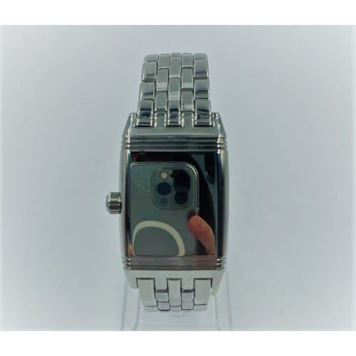 9 - Jaeger-lecoultre Reverso watch with rectangular black face and steel strap.