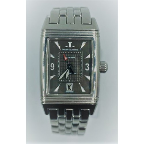 9 - Jaeger-lecoultre Reverso watch with rectangular black face and steel strap.