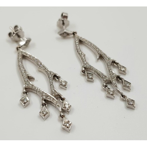 30 - A beautiful pair of 18ct white gold and diamond drop earrings. 5cm drop 9g total weight.