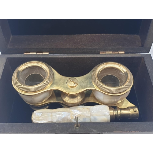 348 - 1920's Mother of Pearl & Brass opera glasses with folding handle, in wooden box. 13x7cm.