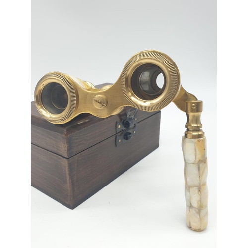 348 - 1920's Mother of Pearl & Brass opera glasses with folding handle, in wooden box. 13x7cm.