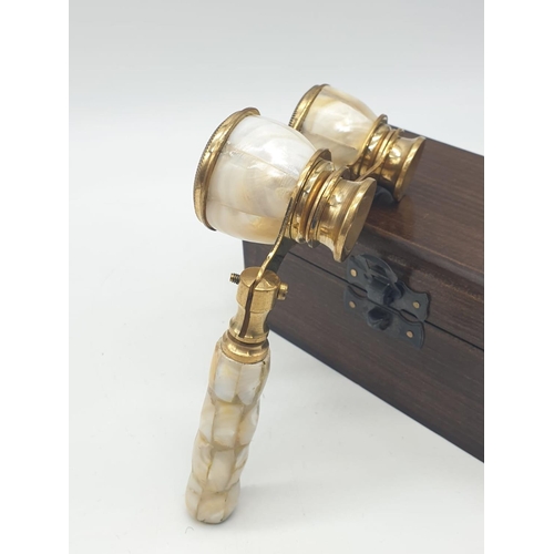 348 - 1920's Mother of Pearl & Brass opera glasses with folding handle, in wooden box. 13x7cm.