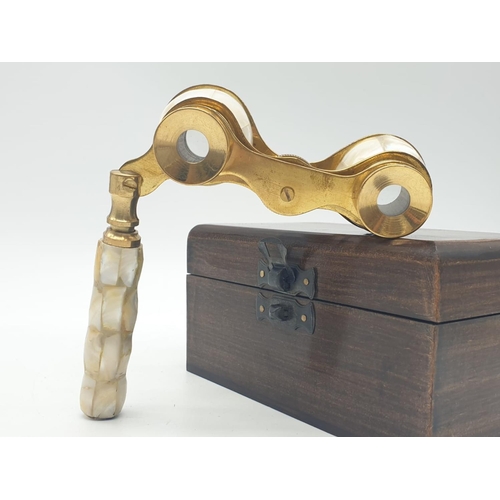 348 - 1920's Mother of Pearl & Brass opera glasses with folding handle, in wooden box. 13x7cm.