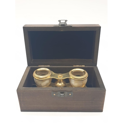 348 - 1920's Mother of Pearl & Brass opera glasses with folding handle, in wooden box. 13x7cm.