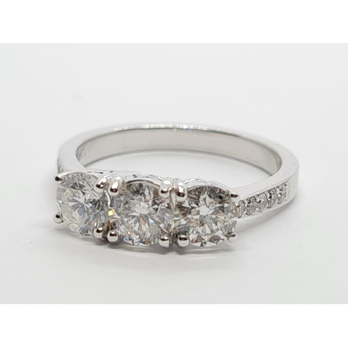 256 - 18ct White Gold with Trilogy set of 1.5ct Diamonds and further encrusted diamonds on the shoulder.  ... 