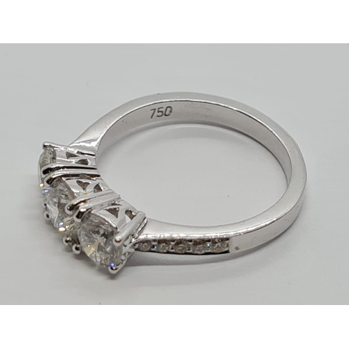 256 - 18ct White Gold with Trilogy set of 1.5ct Diamonds and further encrusted diamonds on the shoulder.  ... 