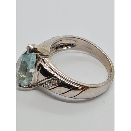 426 - 9ct White Gold Diamond and Aquamarine RING .  5.3g    Size M.