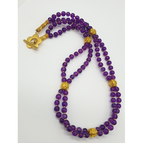 112 - A Mary Quant style necklace and earrings set with synthetic amethyst, following the philosophy of th... 