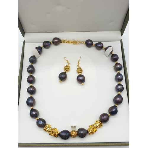 140 - A statement necklace and earrings set with rare, baroque, black pearls and Chinese, gold filled PIXI... 