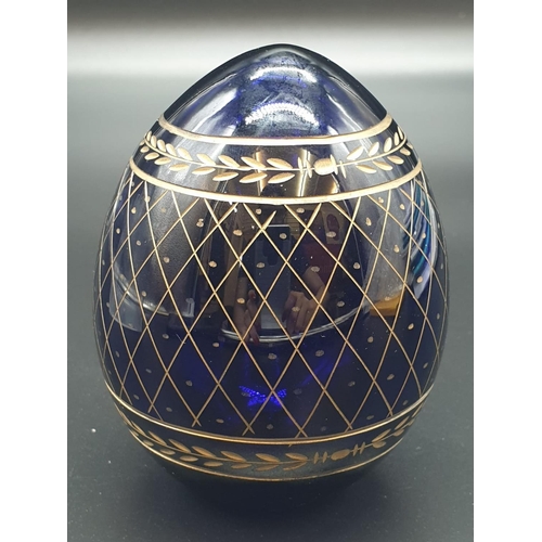 147 - A Russian, Faberge style, cobalt blue, crystal egg, engraved and gilded with the Romanov coat of arm... 