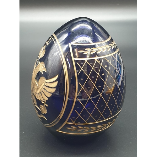 147 - A Russian, Faberge style, cobalt blue, crystal egg, engraved and gilded with the Romanov coat of arm... 