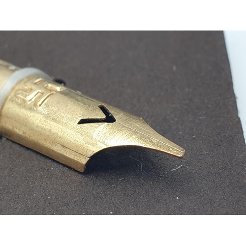 197 - A 19th Century piece of hand writing history: a heavily gilt pen nib with an oblique point, engraved... 