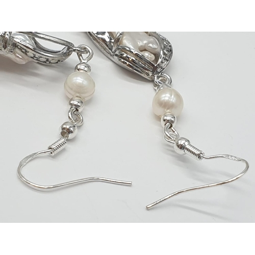 56 - An unusual Biwa pearls and sterling silver necklace and earrings set in a presentation case. Necklac... 