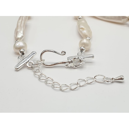 56 - An unusual Biwa pearls and sterling silver necklace and earrings set in a presentation case. Necklac... 