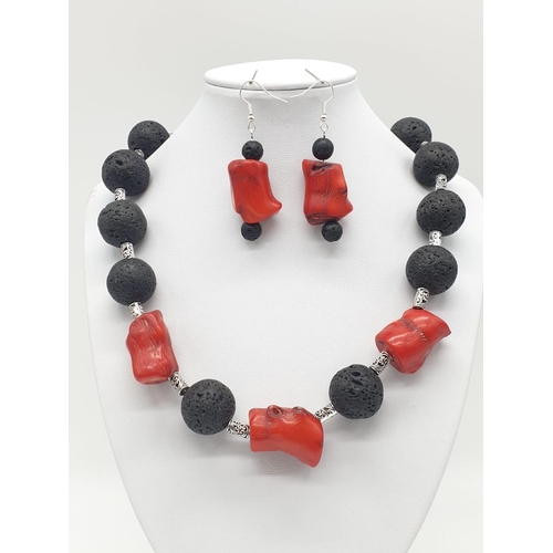 70 - A Hawaiian lava necklace and earrings set, adored with big chunks of Pacific red coral. In a present... 