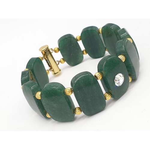 77 - A beautiful articulate jade bracelet in a presentation box. Bracelet length: 20 cm, width: 2 cm.