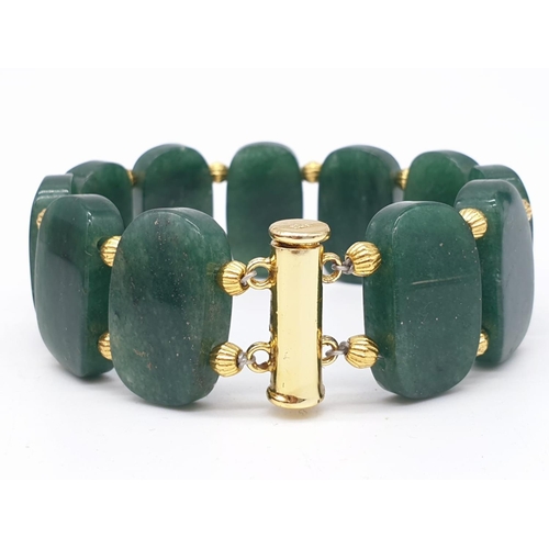 77 - A beautiful articulate jade bracelet in a presentation box. Bracelet length: 20 cm, width: 2 cm.