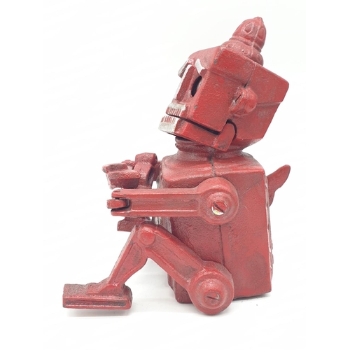 98 - A cast iron, mechanical, money box in the shape of a robot. With moving hands, jaw and eyes. In exce... 