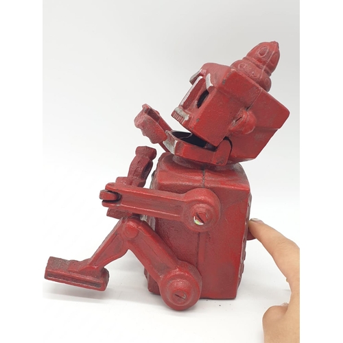 98 - A cast iron, mechanical, money box in the shape of a robot. With moving hands, jaw and eyes. In exce... 