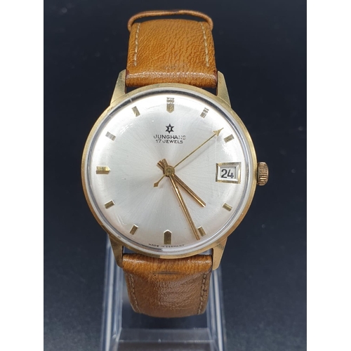 152 - A vintage 14ct gold Junghans men's watch. Gold case with silver dial. Comes with original leather st... 