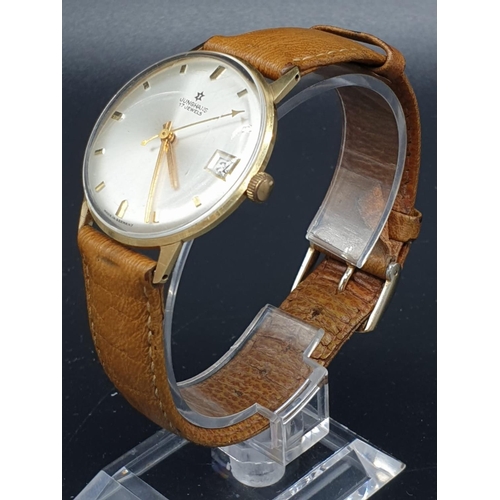 152 - A vintage 14ct gold Junghans men's watch. Gold case with silver dial. Comes with original leather st... 