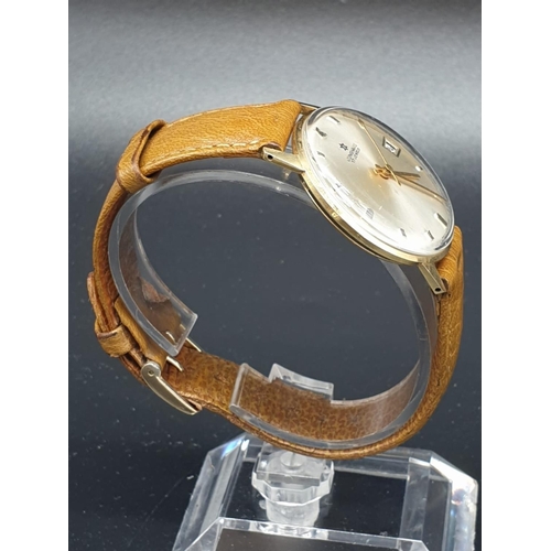 152 - A vintage 14ct gold Junghans men's watch. Gold case with silver dial. Comes with original leather st... 