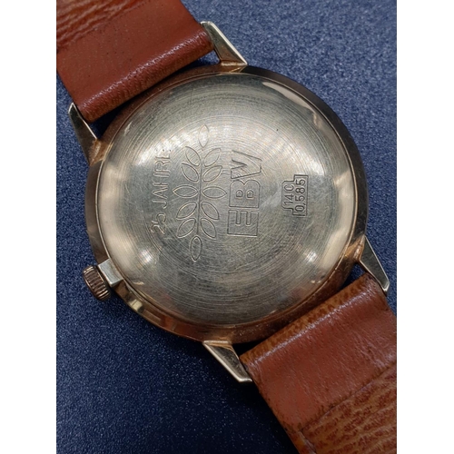 152 - A vintage 14ct gold Junghans men's watch. Gold case with silver dial. Comes with original leather st... 