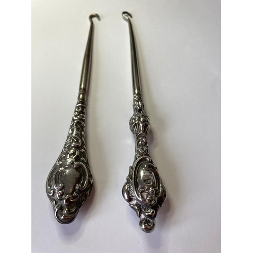 135 - 2 x Silver Handled Antique Victorian/Edwardian Hallmarked BUTTONERS. Having ornate scroll work to to... 