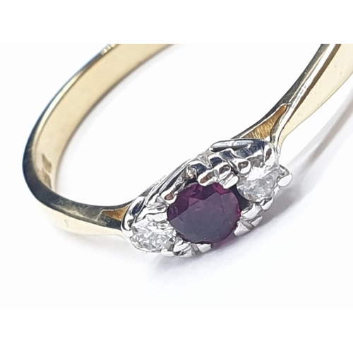 139 - 18ct yellow gold diamond and ruby 3 stone ring. Size S and weighs 2.66g.