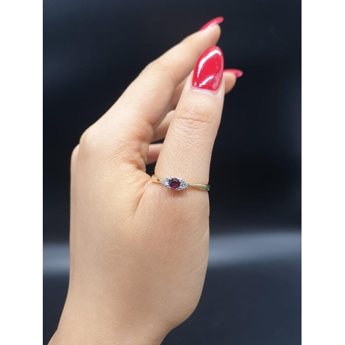 139 - 18ct yellow gold diamond and ruby 3 stone ring. Size S and weighs 2.66g.