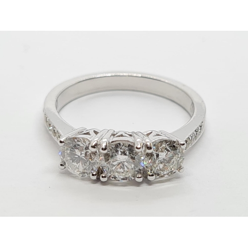 69 - 18ct White Gold with Trilogy set of 1.5ct Diamonds and further encrusted diamonds on the shoulder.  ... 