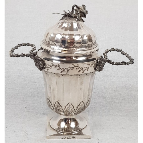 58 - An Antique small Silver Urn. Silver Wire Handles, ribbed body and lid, finished with a wilting Rose ... 