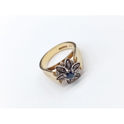 174 - 18ct Gold and Sapphire RING in floral design.  6.58g   Size: M