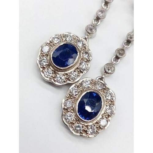 144 - Pair of 14ct White Gold Drop EARRINGS with brilliant cut Diamonds and central Sapphire.   6.6g     3... 