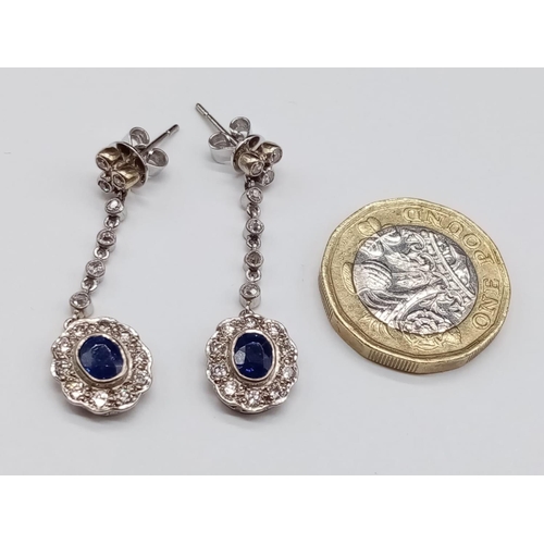 144 - Pair of 14ct White Gold Drop EARRINGS with brilliant cut Diamonds and central Sapphire.   6.6g     3... 