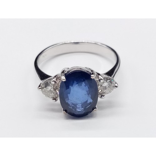 25 - 18ct White Gold RING set with one oval cut natural Sapphire and 2x round brilliant cut natural Diamo... 