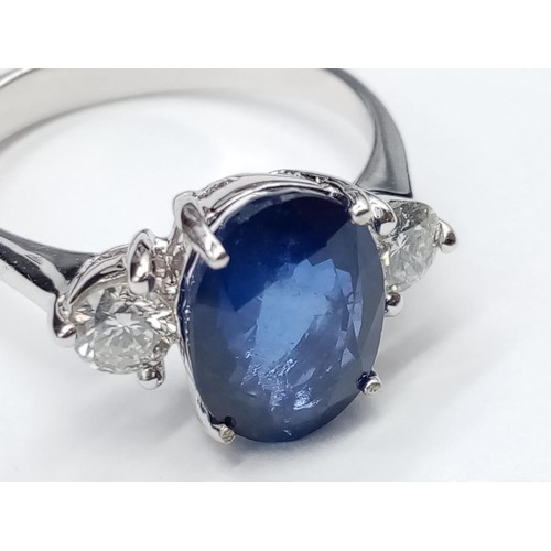 25 - 18ct White Gold RING set with one oval cut natural Sapphire and 2x round brilliant cut natural Diamo... 