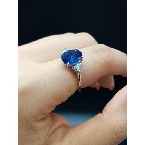 25 - 18ct White Gold RING set with one oval cut natural Sapphire and 2x round brilliant cut natural Diamo... 