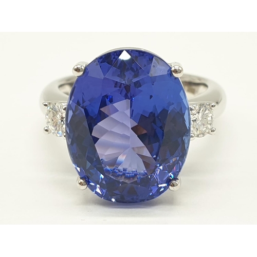 996 - 18ct White gold ring with a large tanzanite centre stone flanked by diamonds. 8.0g total weight and ... 