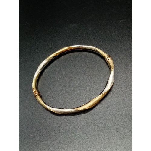 95 - 9ct Yellow and White Gold Twisted BANGLE.  6.1g  6.5cm inner diameter.  in a Jeweller's Presentation... 