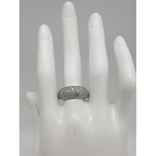 765 - 18ct diamond encrusted stylist ring. Weighs 5.6g and is a size O.