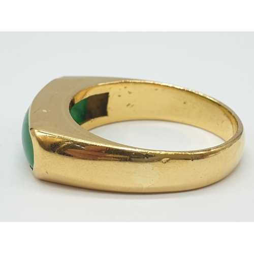 667 - 22ct gold ring with natural jade stone. 7.7g in weight and size T.