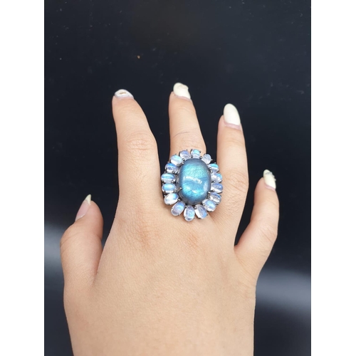 570 - 10.50 Ct Moonstones & 14.25 Ct Labradorite set within a blackened silver ring, weight 11.62g and siz... 